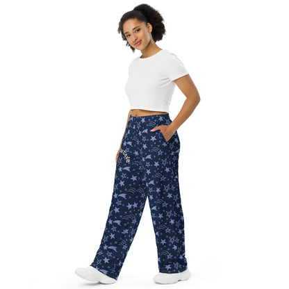 Woman wearing navy blue patterned pants with  a 'Fun Wear Code' text logo and a white crop top on a white background
