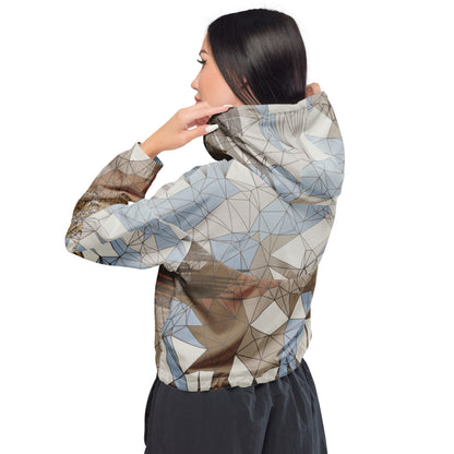 Person wearing a geometric patterned windbreaker on a white background