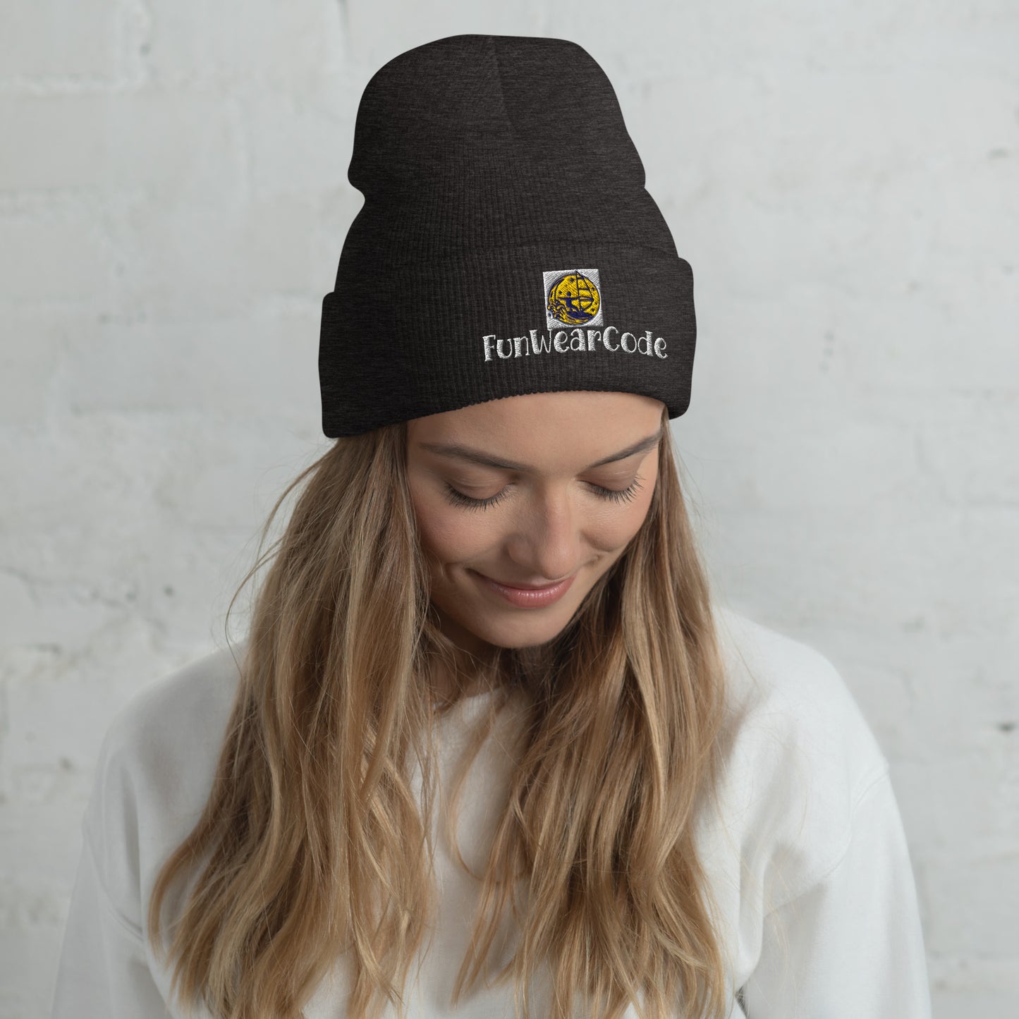 Woman wearing a black beanie with 'Fun Wear Code' logo against a light gray background