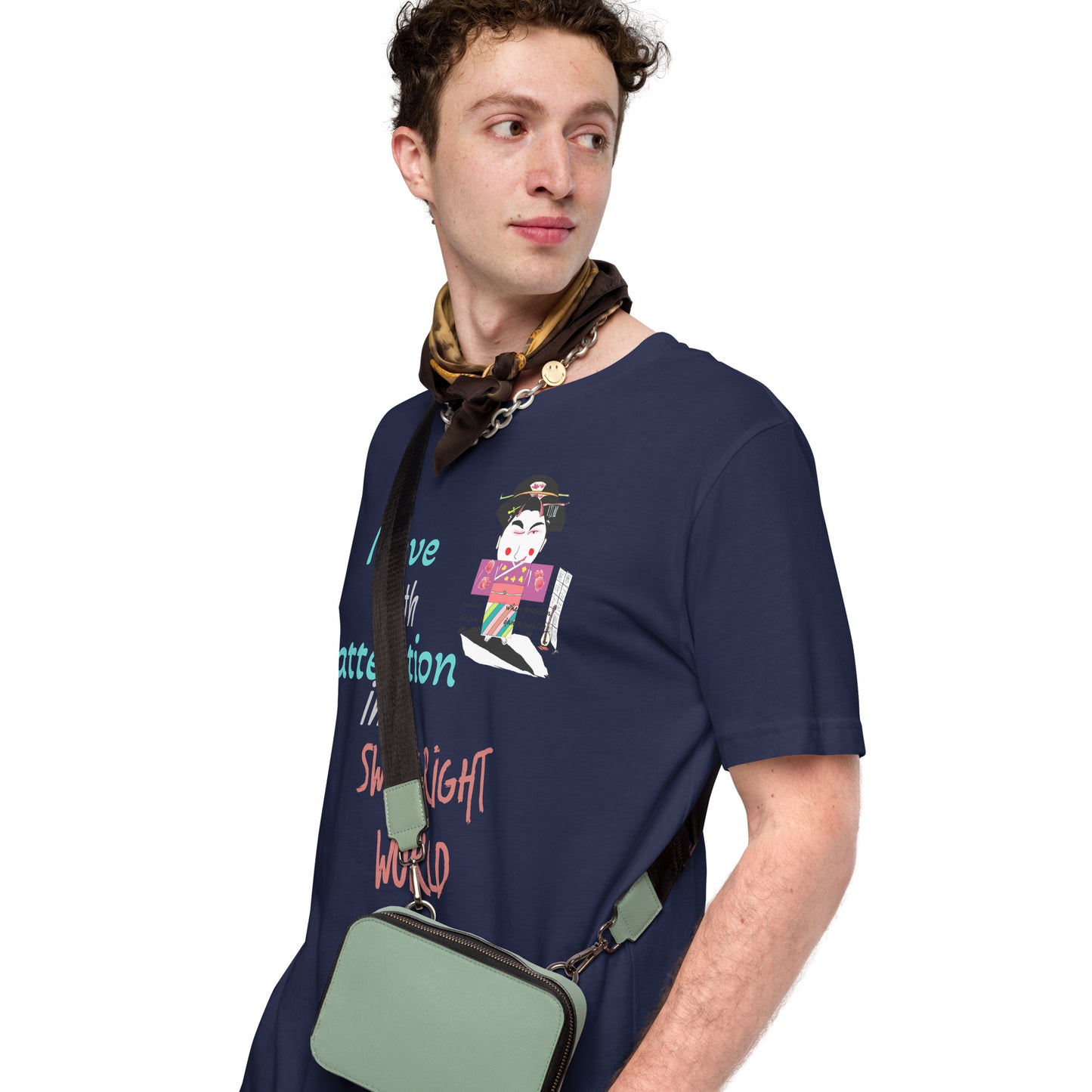 Man wearing a navy blue t-shirt with colorful text and a playful geisha graphic design, holding a green bag on a white background